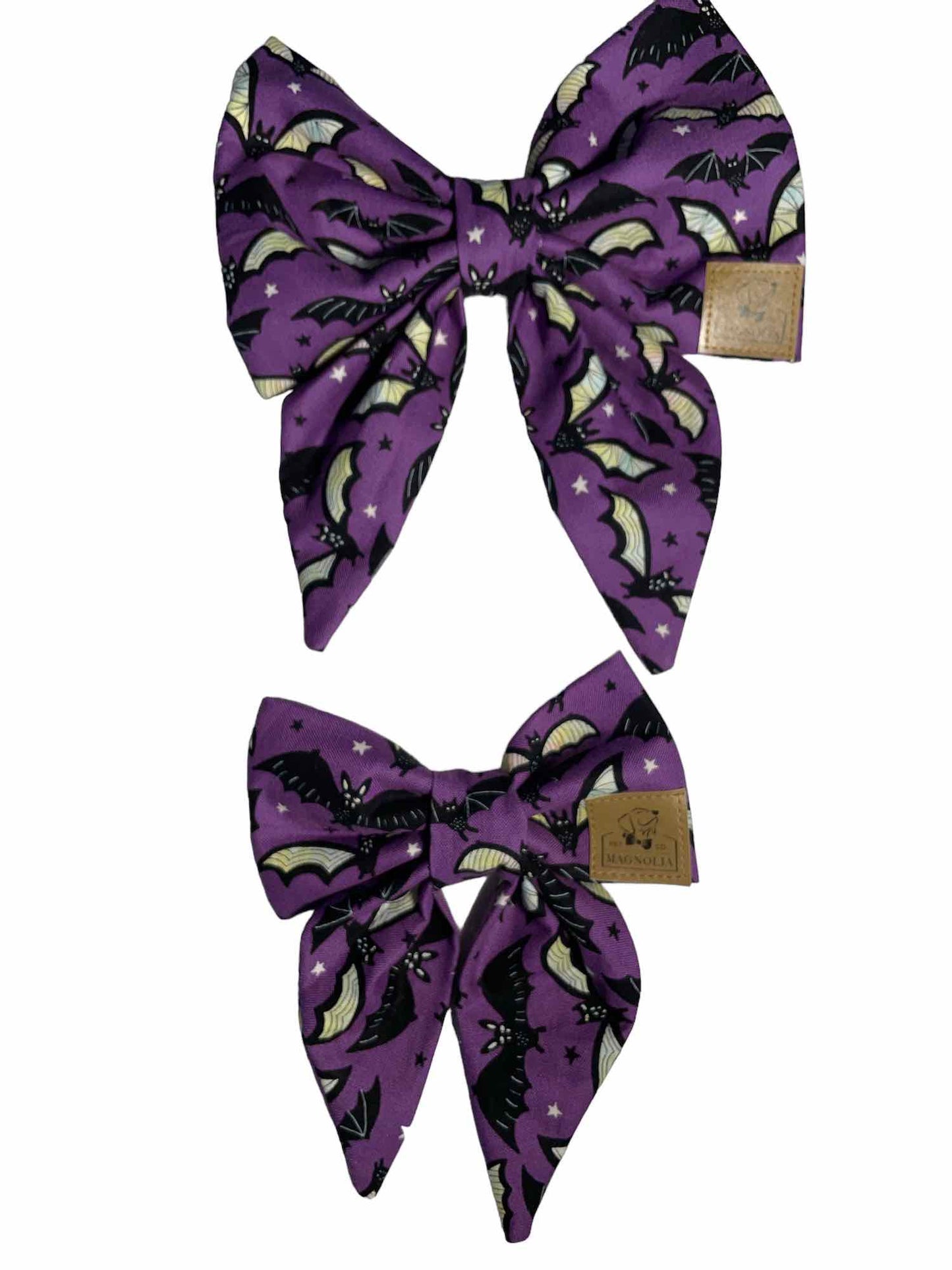 Our Plum Batty dog bow tie features black and white bats on a dark purple background. Glow in the Dark. Handmade in the USA.