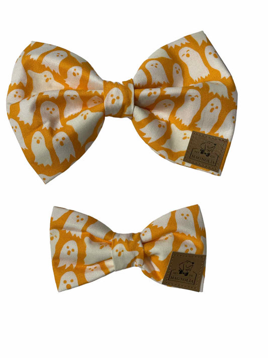 Featuring a vibrant orange background adorned with glow-in-the-dark white ghosts, this bow is perfect for adding a dash of Halloween charm to any occasion