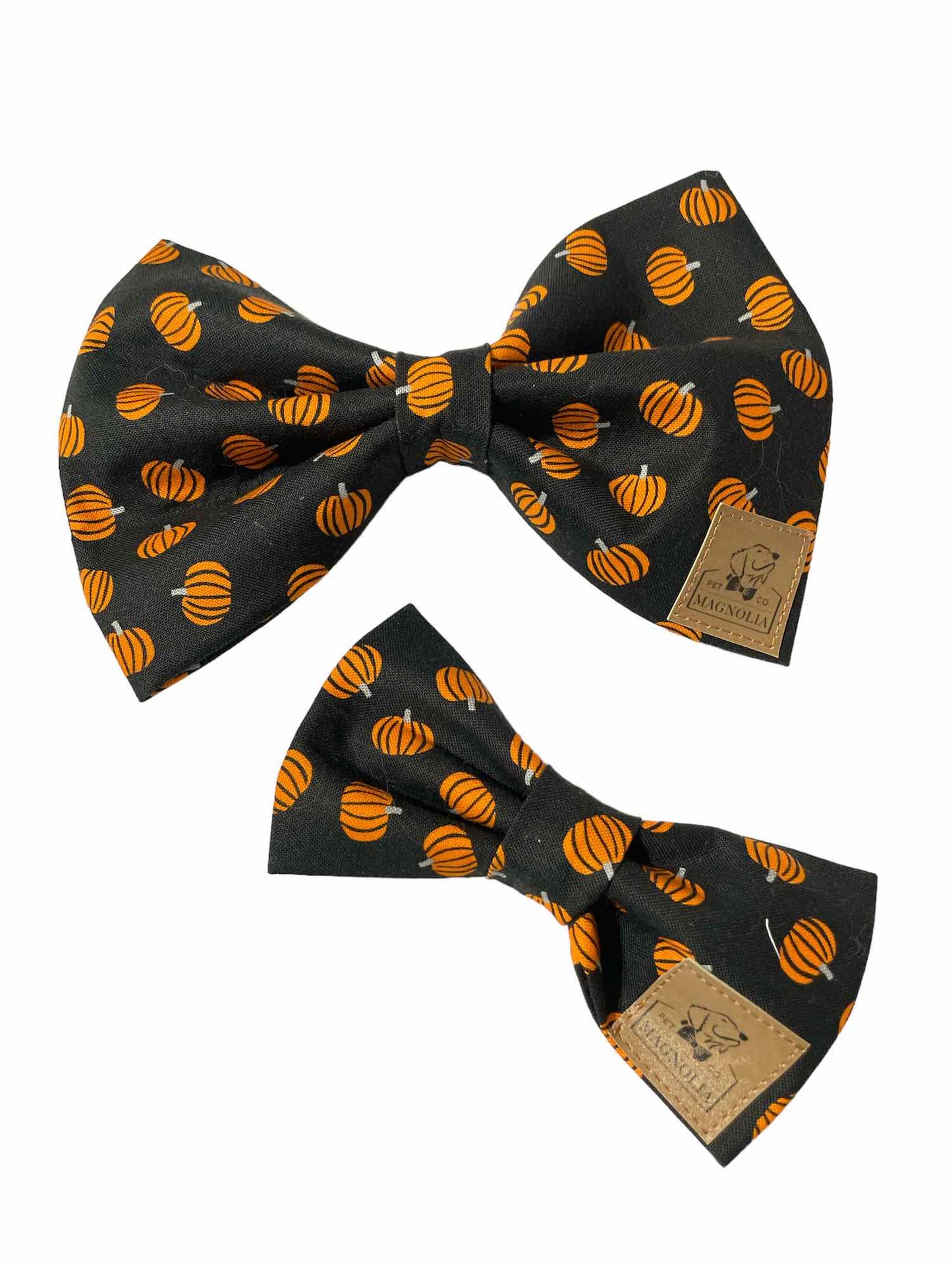 This stylish accessory features a sleek black background that makes the vibrant orange pumpkins scattered across the fabric pop, creating a striking and festive look.