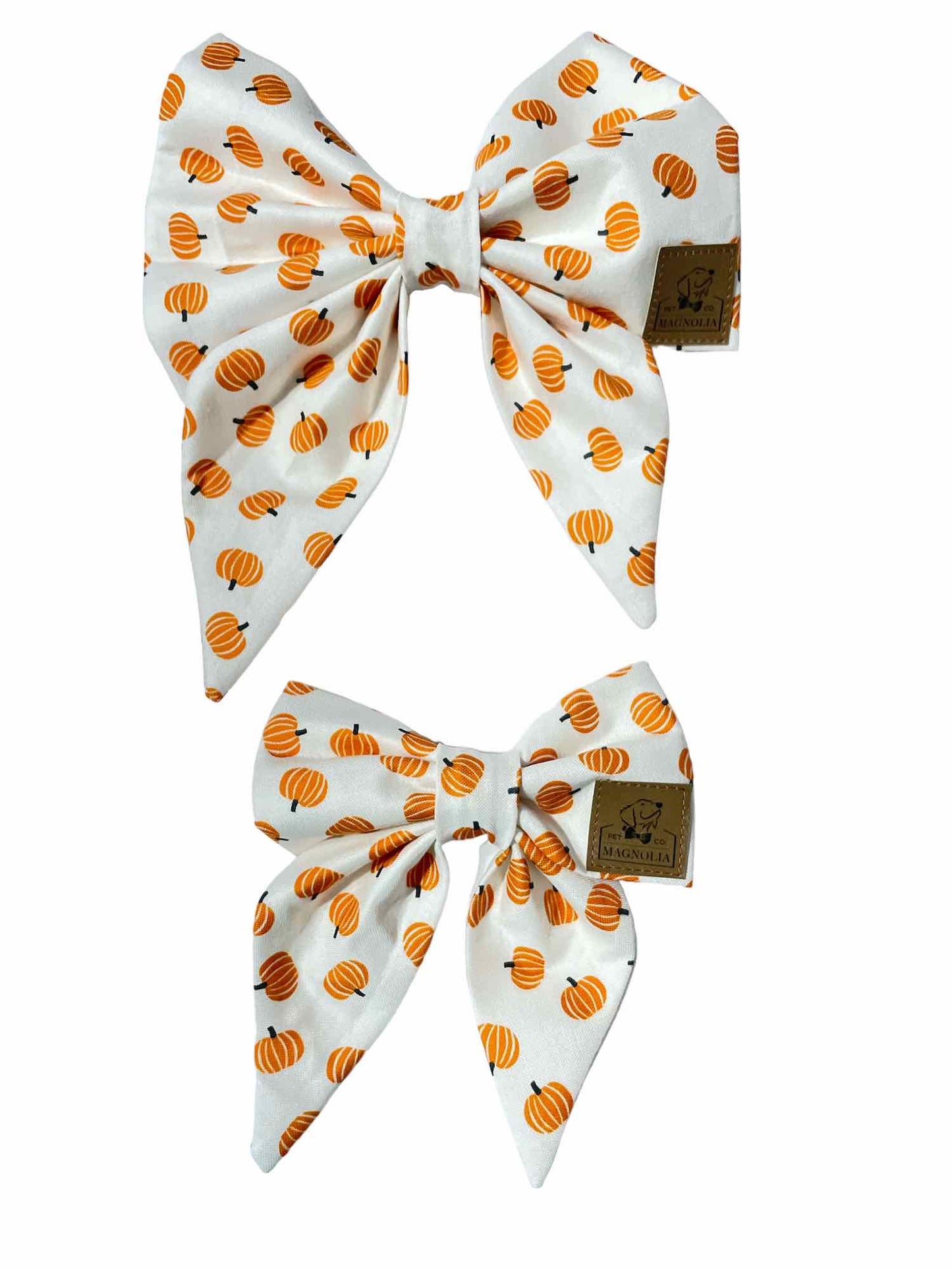 crafted with a crisp white background, providing a clean and elegant canvas for the vibrant design. Scattered across the fabric are small, cheerful orange pumpkins