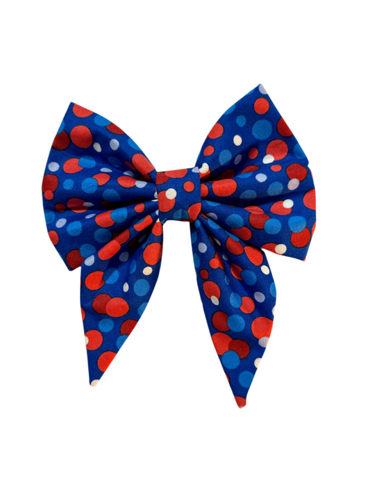 Featuring large red, white, and blue polka dots on a vibrant blue background