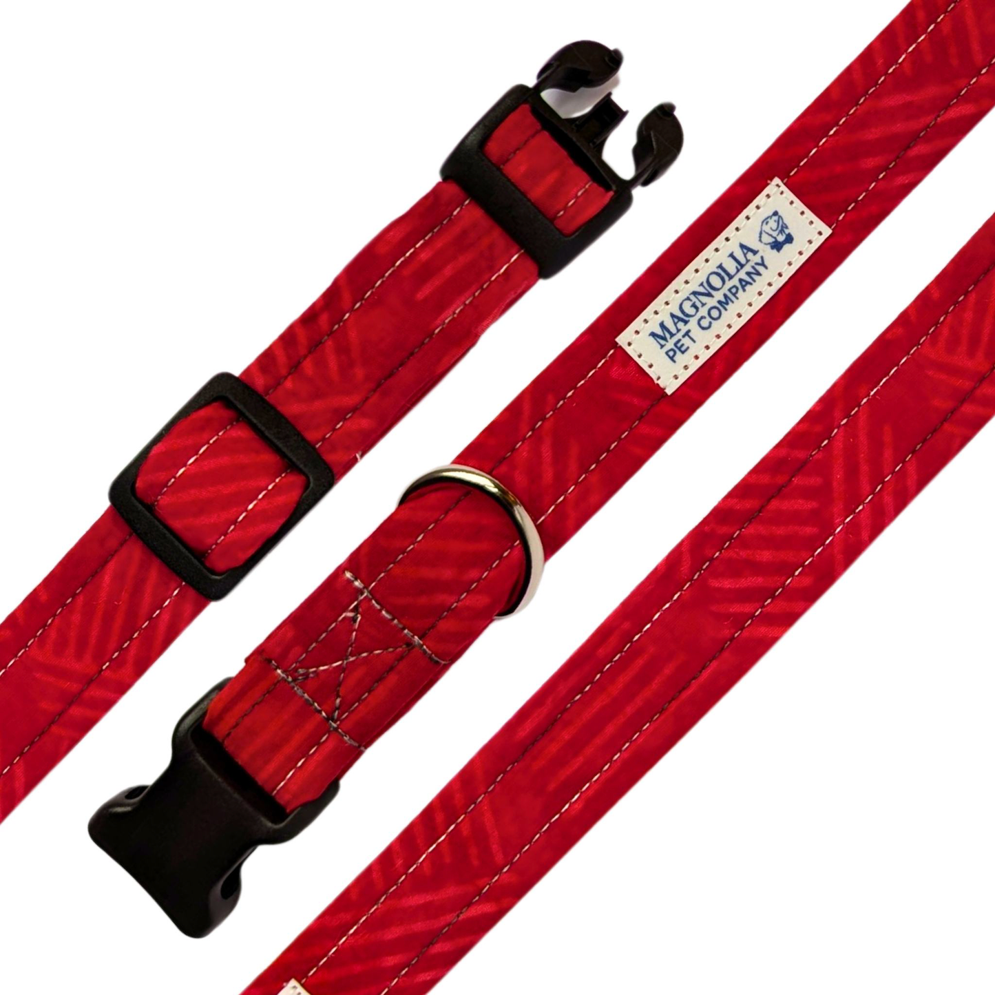 This collar features a bright red hue, accented with a faint batik design that adds a subtle yet elegant touch.