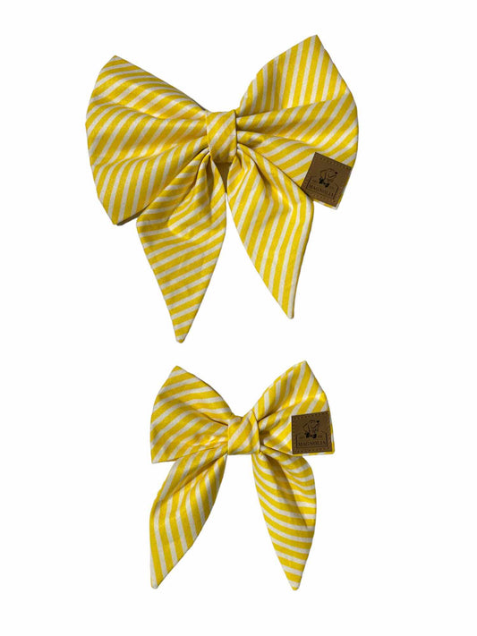 This charming accessory features a classic pattern of yellow and white stripes, offering a timeless yet cheerful design that brightens up any occasion.