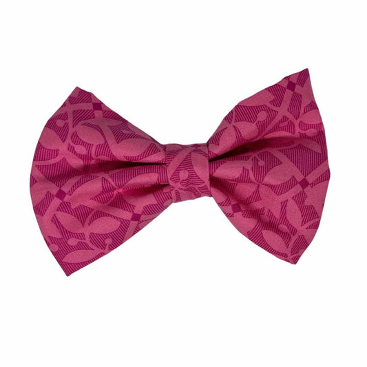 Dog bow tie featuring bright pink fabric adorned with enchanting dark pink floral designs.