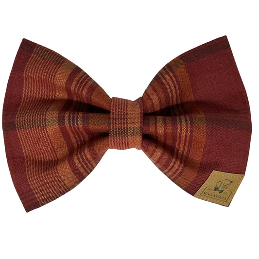 Dog bow tie Featuring a rich maroon background adorned with a muted beige plaid pattern, this bow tie exudes a timeless, sophisticated charm
