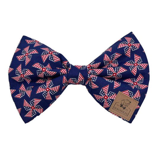 This striking Patriotic Pinwheel Dog Bow Tie featuring cute American flag pinwheels set against a rich navy background by Magnolia Pet Company.