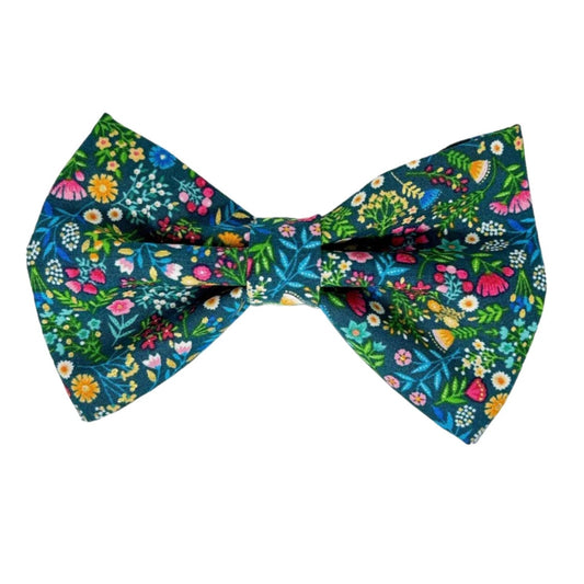 beautifully illustrated garden scene, brought to life with vibrant shades of blue, green, pink, orange, and yellow. Set against a deep blue background, the colorful floral and botanical designs