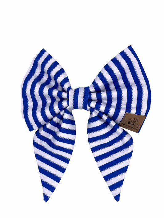 Featuring striking sapphire blue stripes on a crisp white background, this bow is perfect for cheering on your favorite team in style.