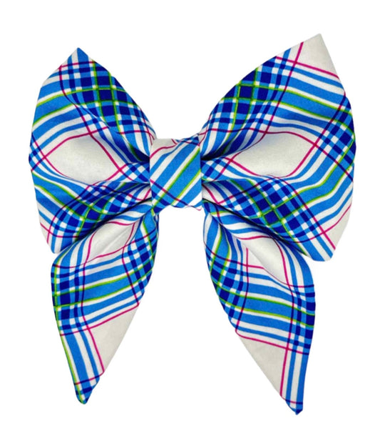 Featuring a classic blue tartan plaid accented with vibrant hot pink highlights, this bow seamlessly blends tradition with a modern twist.