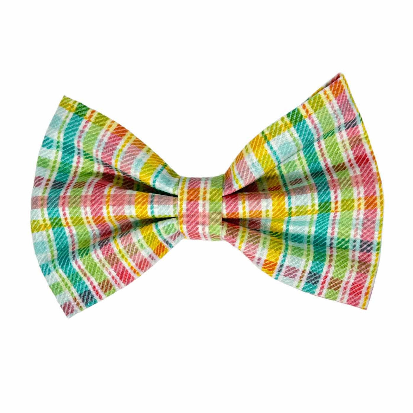This timeless dog bow features a charming plaid pattern in vibrant hues of red, aqua, green, and blue, set against a crisp white background by Magnolia Pet Company.