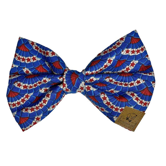 Dog bow tie featuring a vibrant festive Fourth of July bunting print with red stars. Magnolia Pet Company
