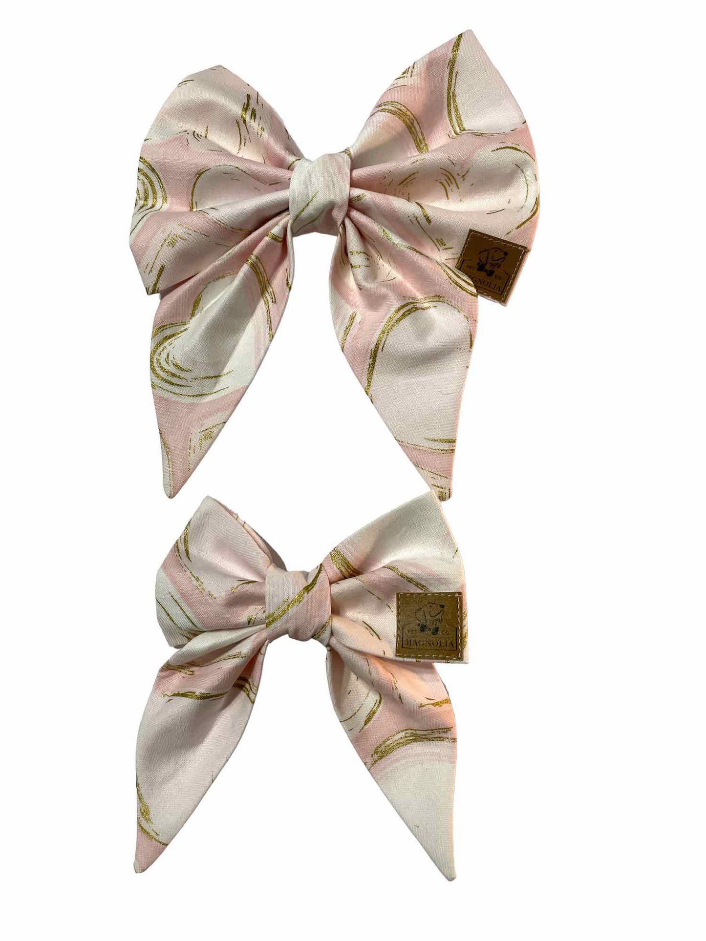 Introducing our adorable dog bow with shimmering golden hearts set against a soft pink background! This charming accessory adds a touch of elegance to your furry friend's ensemble, perfect for any occasion. Crafted with love and attention to detail, it's not just a bow, but a statement of style and affection. Let your pup shine with every wag of their tall!