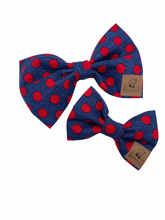 The rich dark navy background is perfectly complemented by vibrant red polka dots, creating a timeless yet contemporary look that suits dogs of all breeds and sizes
