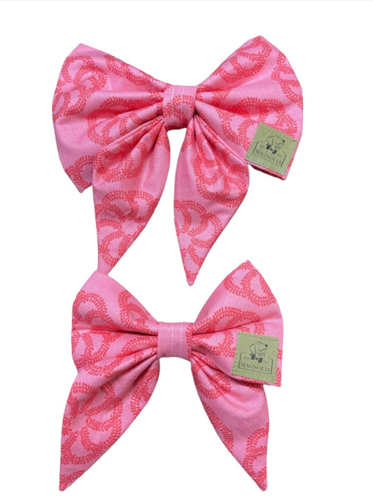 This beautiful accessory features a vibrant floral design set against a soft pink fabric background, creating a look that's both elegant and eye-catching