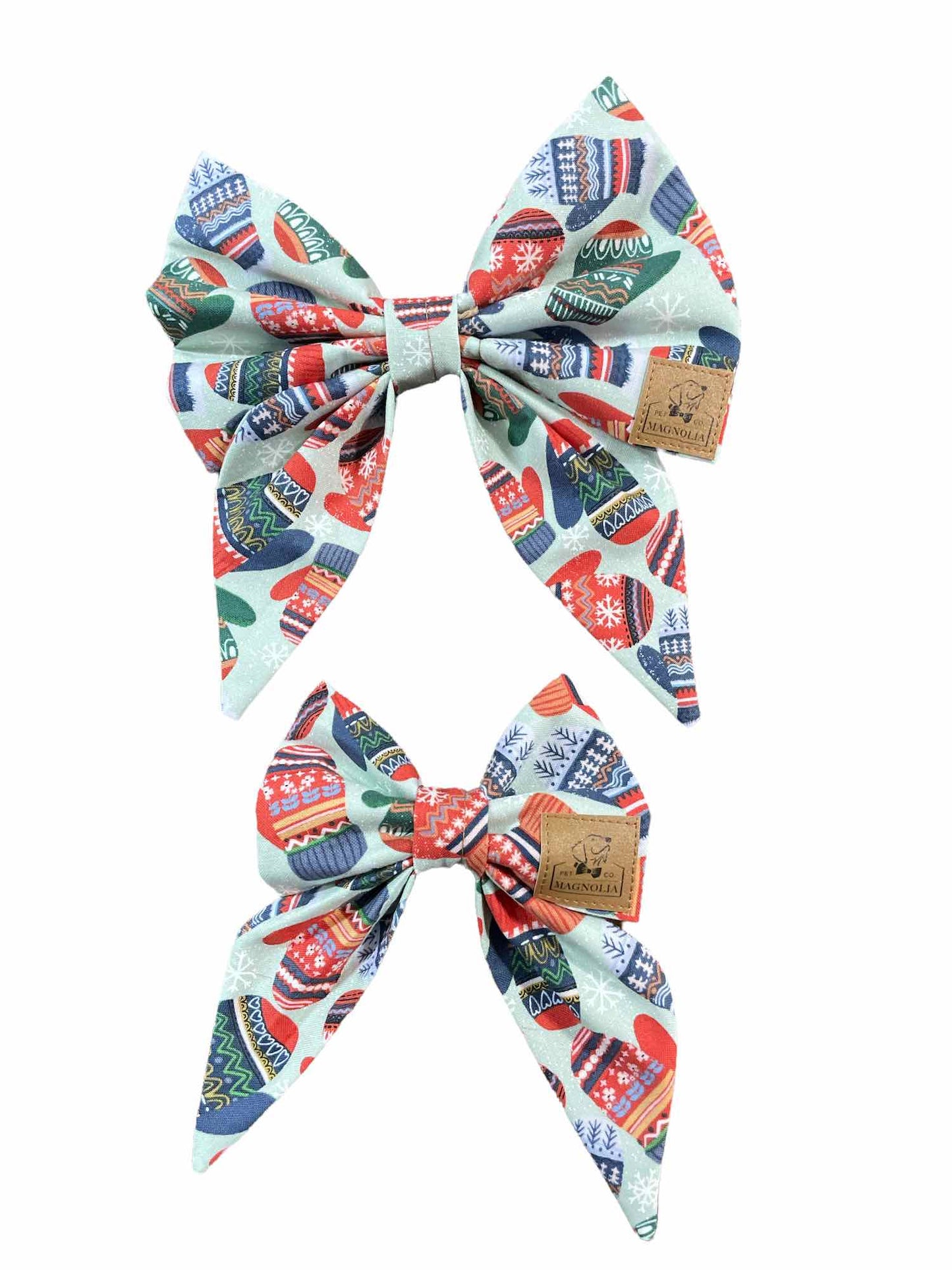This adorable accessory features a soft light blue fabric, beautifully adorned with a delightful pattern of vintage mittens in shades of blue, red, and green