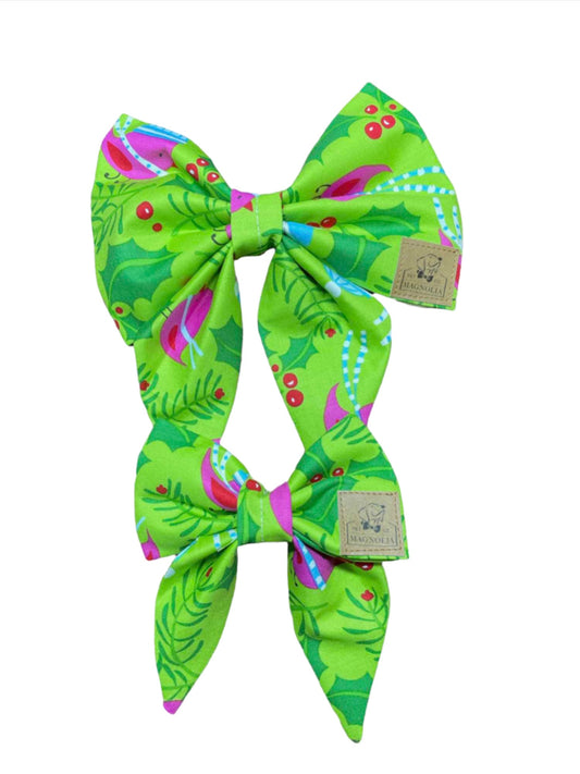 This lively accessory features a vibrant green fabric adorned with whimsical hot pink winter birds and berries, creating a delightful and festive design