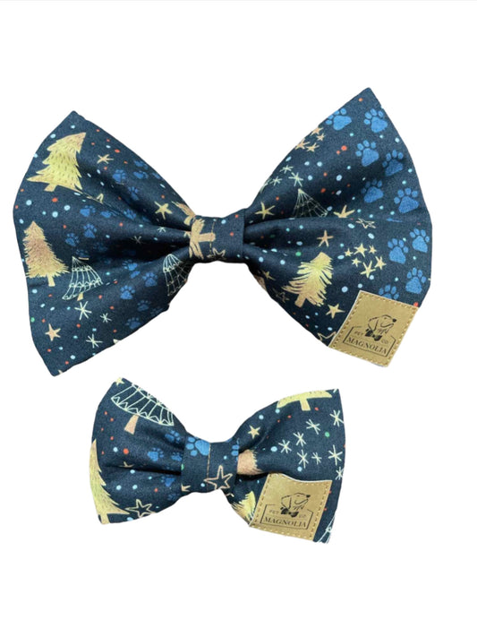 This exquisite accessory is crafted from luxurious navy blue fabric adorned with golden trees, twinkling stars, and faint blue paw prints, creating a magical nighttime forest scene.