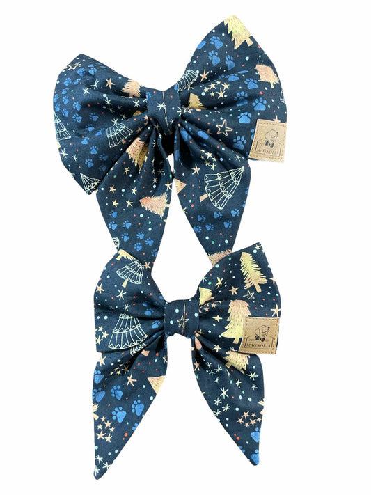 This exquisite accessory is crafted from luxurious navy blue fabric adorned with golden trees, twinkling stars, and faint blue paw prints, creating a magical nighttime forest scene.