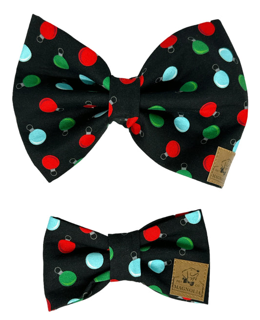 Dog bow tie featuring a sleek black background adorned with vibrant red, green, and blue ornaments