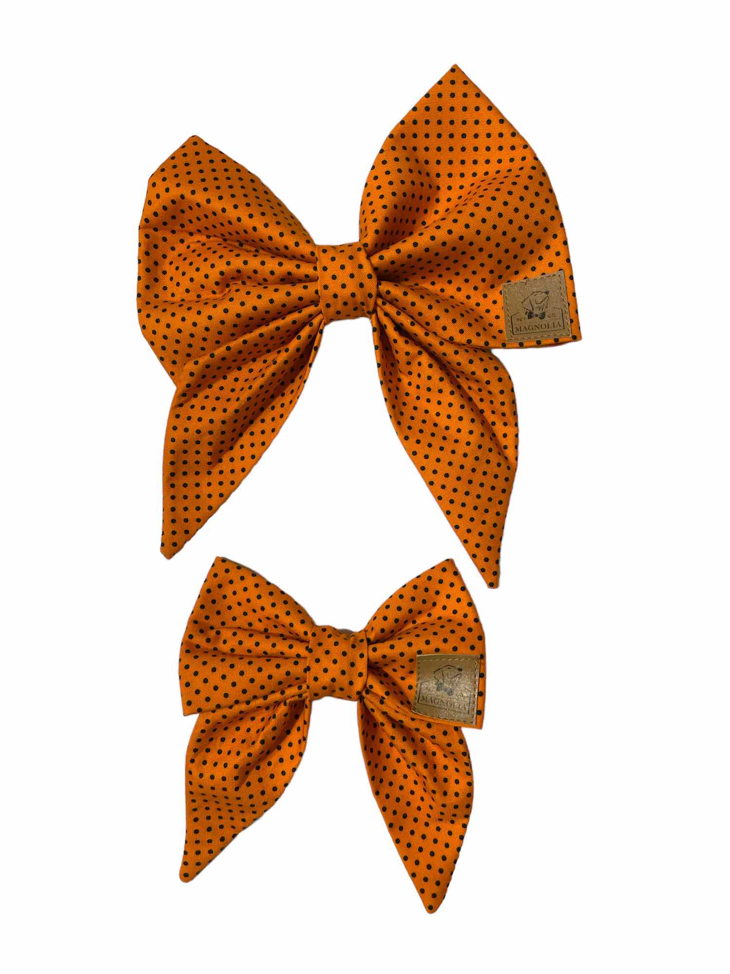 This charming accessory features a vibrant orange fabric adorned with petite black polka dots, adding a fun and playful touch to your furry friend's wardrobe