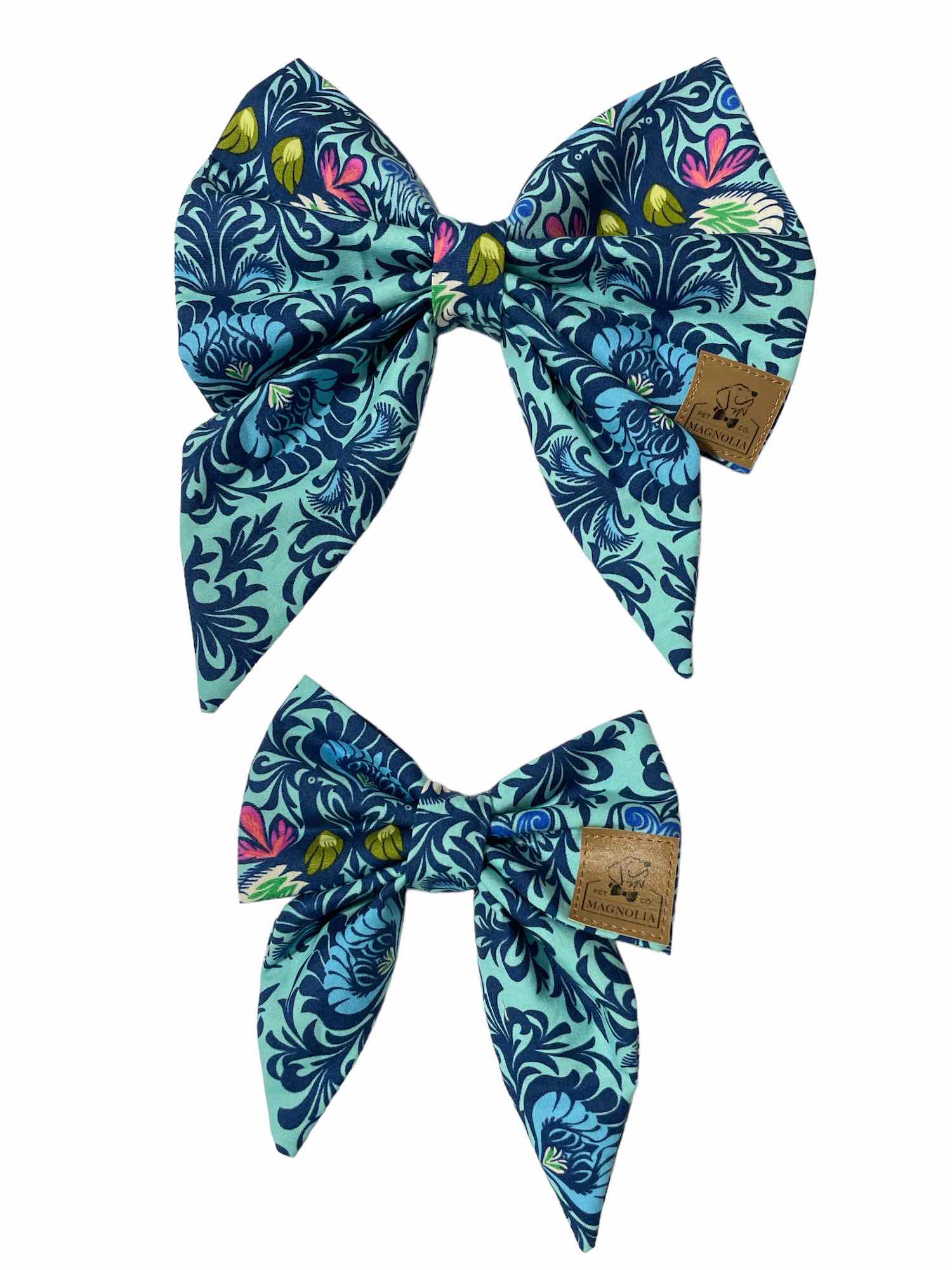 This stunning accessory features a bright blue fabric background adorned with a medium blue paisley pattern accented with vibrant touches of yellow and pink