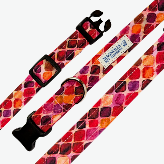his vibrant pomegranate-colored collar features a stunning diamond mosaic pattern in shades of blue, purple, orange, and hot pink, creating a bold and eye-catching design.