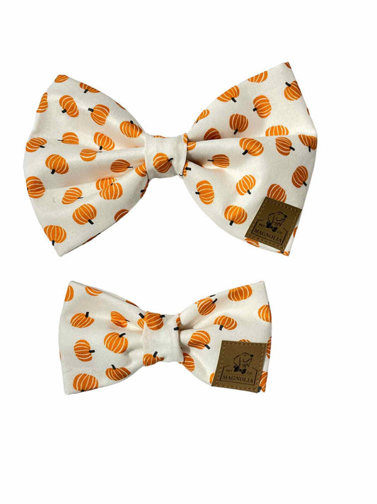 crafted with a crisp white background, providing a clean and elegant canvas for the vibrant design. Scattered across the fabric are small, cheerful orange pumpkins