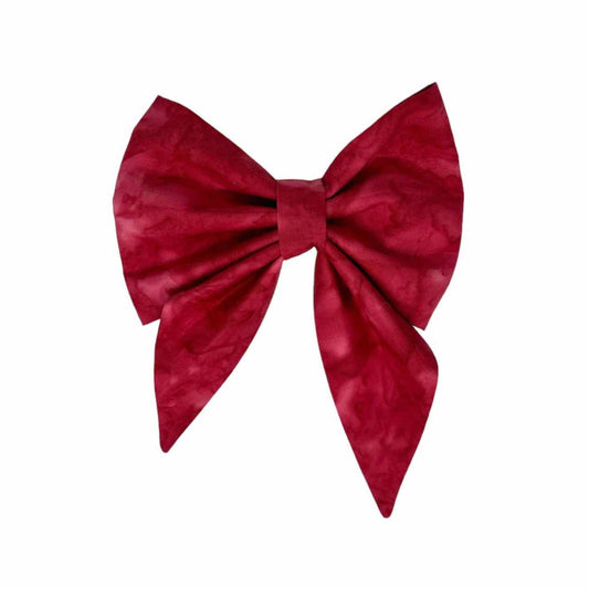 Elevate your furry friend's style with our Red Wine Cabernet Batik Dog Bow, the perfect accessory for both park strolls and dining in style. Meticulously crafted with attention to detail and quality, this bow tie effortlessly blends style and comfort for your canine companion.  Featuring a rich Cabernet hue and intricate batik-inspired patterns, this bow tie exudes sophistication and worldly charm. 