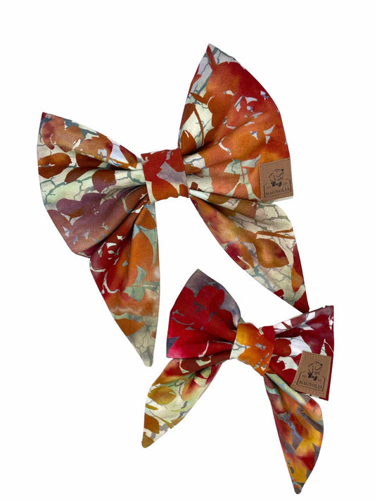 This bow represents and autumn fall leaves in muted hues of burnt orange, olive and brown tones