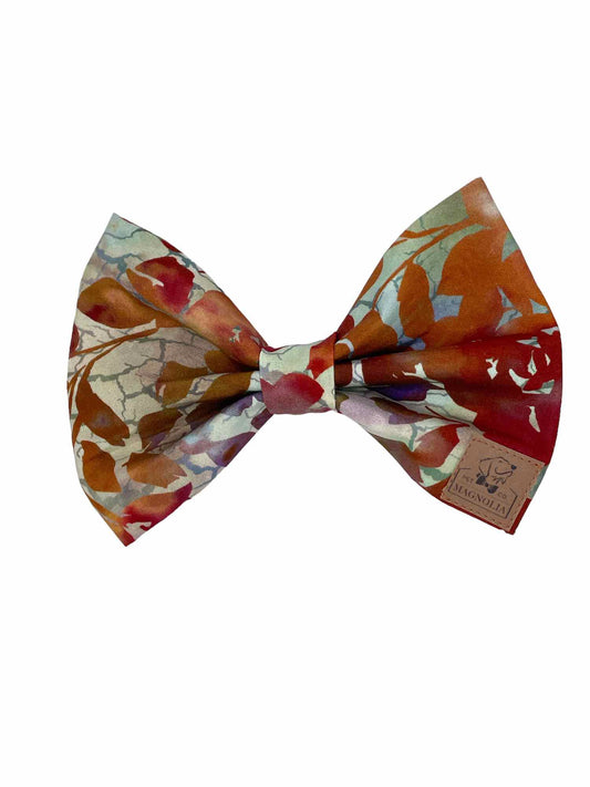 This bow represents and autumn fall leaves in muted hues of burnt orange, olive and brown tones