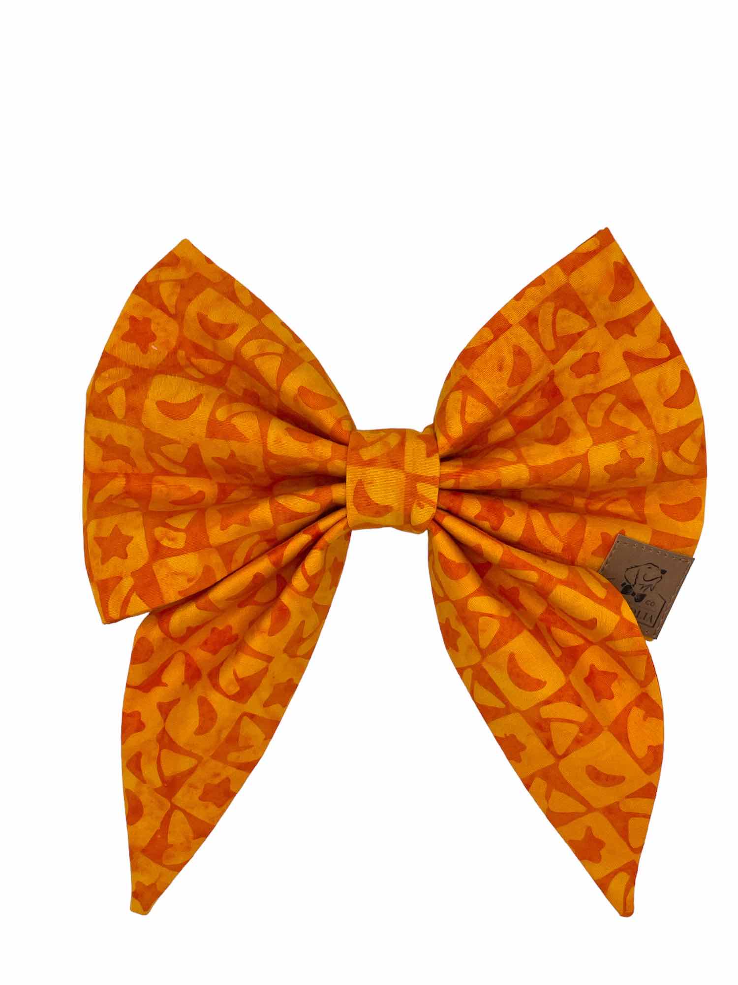 Crafted in a vibrant, eye-catching bright orange, this bow features an intricate pattern of checkered boxes, each adorned with whimsical stars and charming witches hats