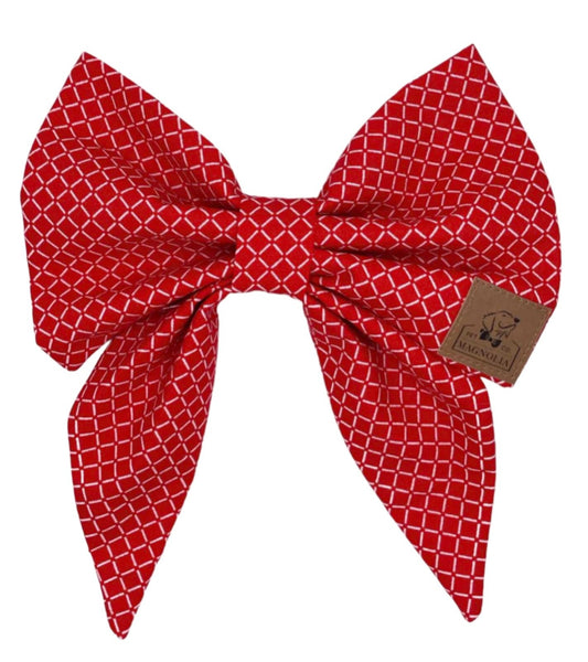 This exquisite dog bow features a striking red background adorned with crisp white diamond shapes, creating a sophisticated and eye-catching pattern that's perfect for any occasion