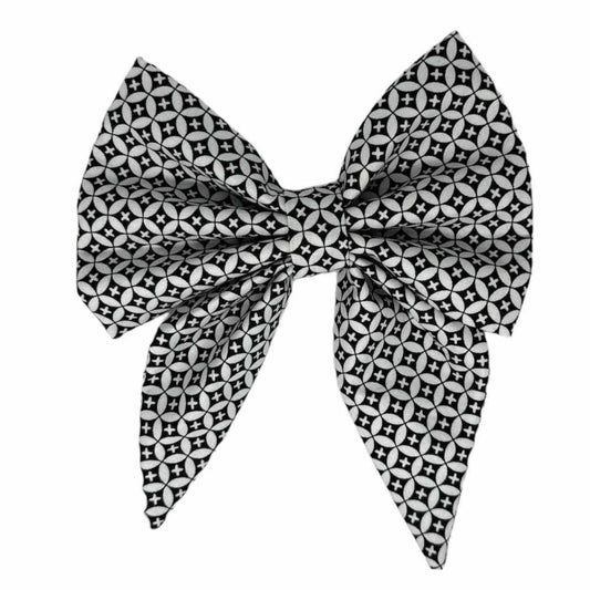 Dog bow featuring a striking pattern of black and white geometric tiles, this bow tie exudes contemporary elegance and style.