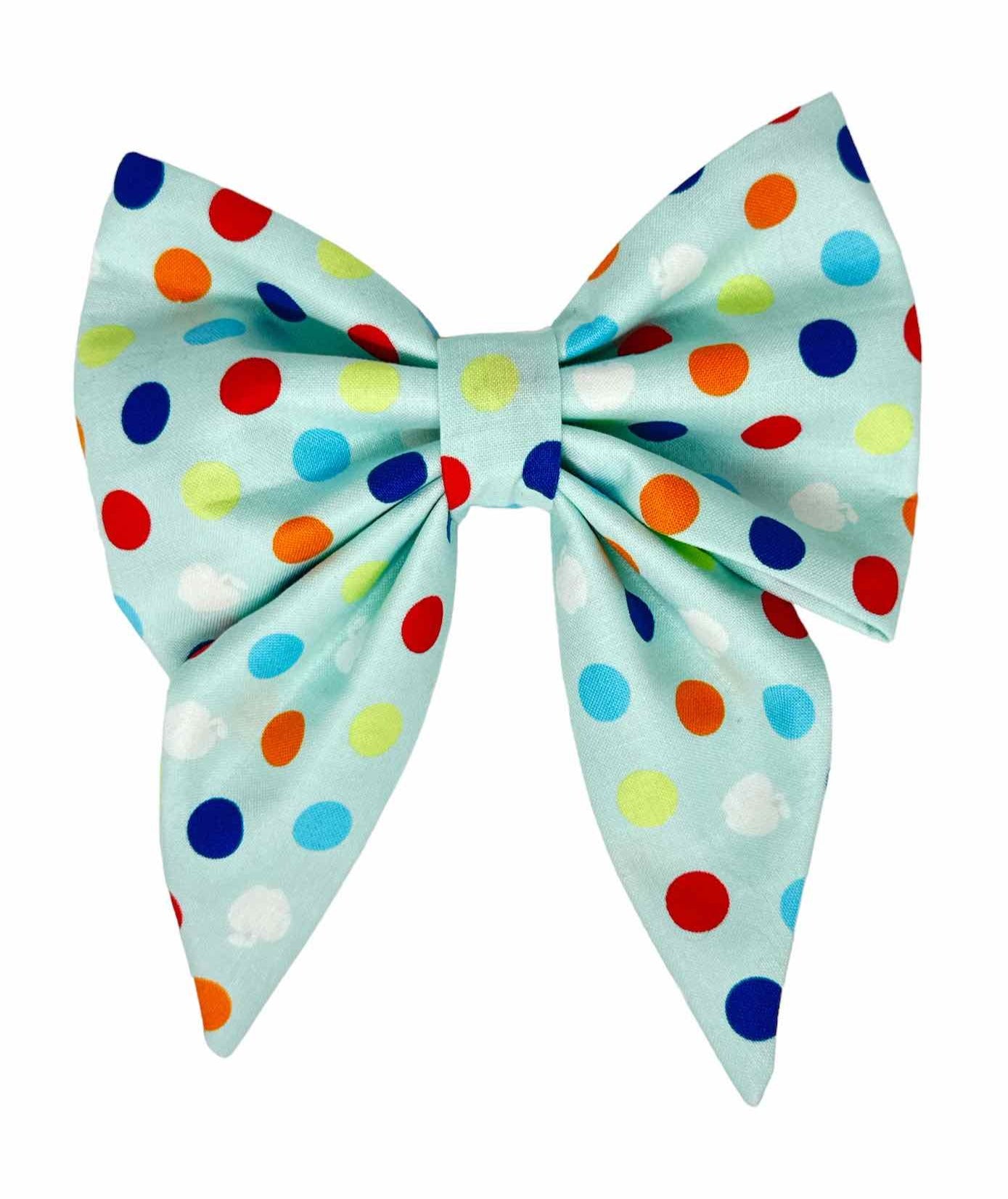 Dog bow featuring a light blue fabric background sprinkled with vibrant polka dots in bright yellow, green, red, blue, and white, this bow tie is the perfect accessory to add a splash of fun and color to your dog's look. Magnolia Pet Company
