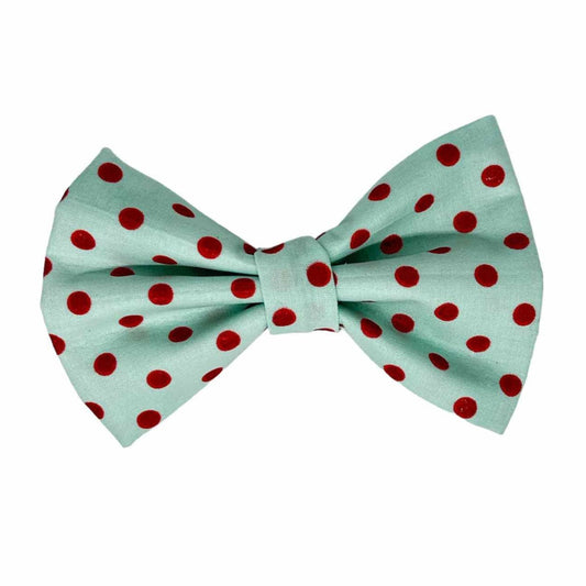 This vibrant accessory features a delightful light blue-green fabric adorned with big, sparkling red polka dots. Perfect for adding a pop of color and a touch of whimsy, this bow ensures your furry friend stands out in any crowd
