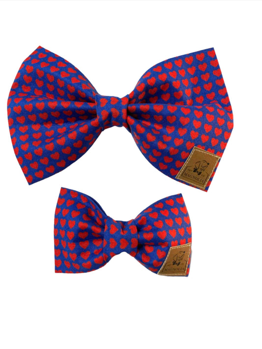 Let your furry friend be the center of attention this Valentine's Day with our adorable Pawsome Love Dog Valentine Bowtie. Crafted with love and attention to detail, this charming accessory features a delightful pattern of bright red hearts on a classic navy background, making it the perfect blend of festive flair and timeless elegance. 