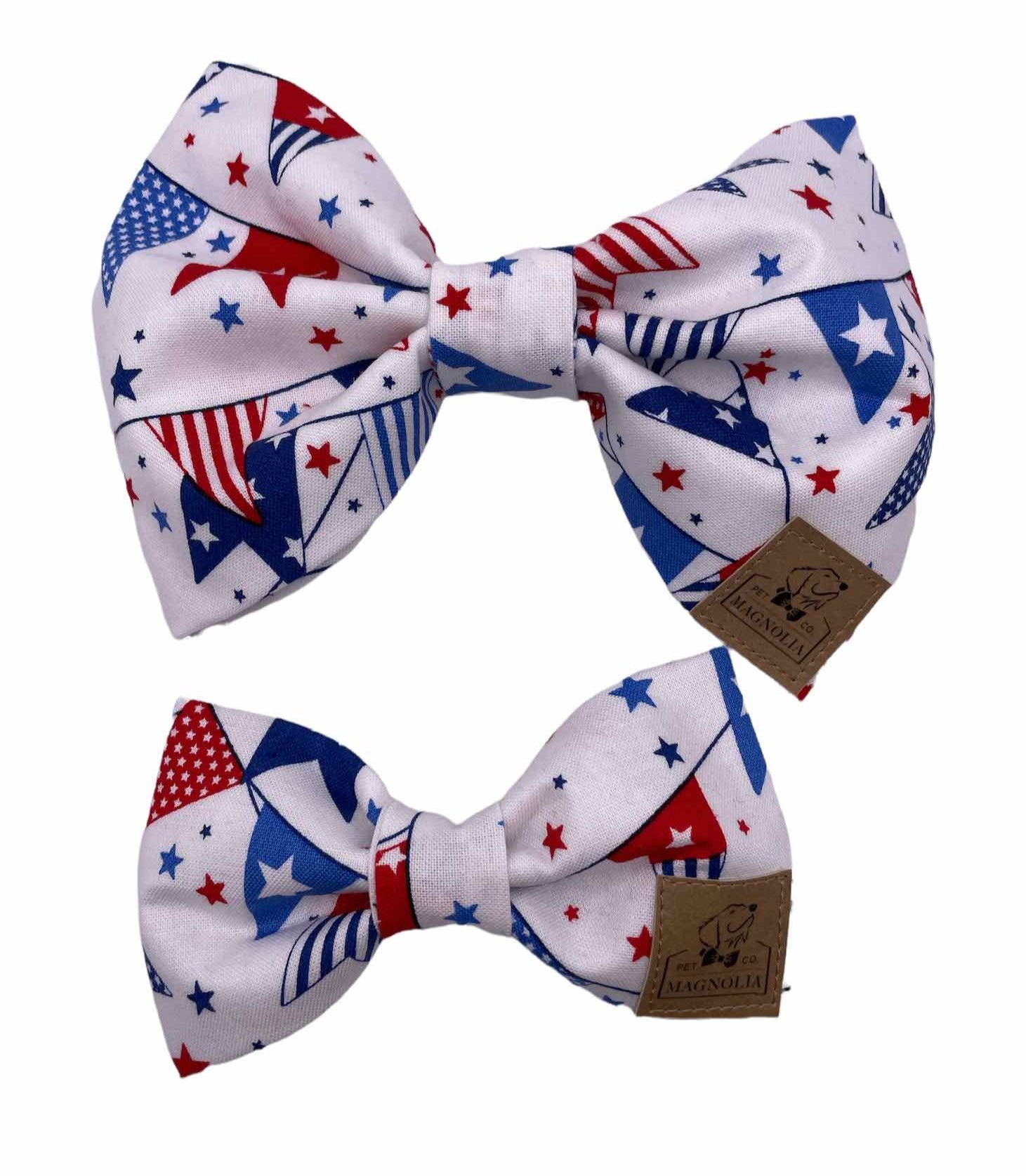 Dog bow tie featuring a lively pattern of red, white, and blue pennants against a crisp white fabric background by Magnolia Pet Company.