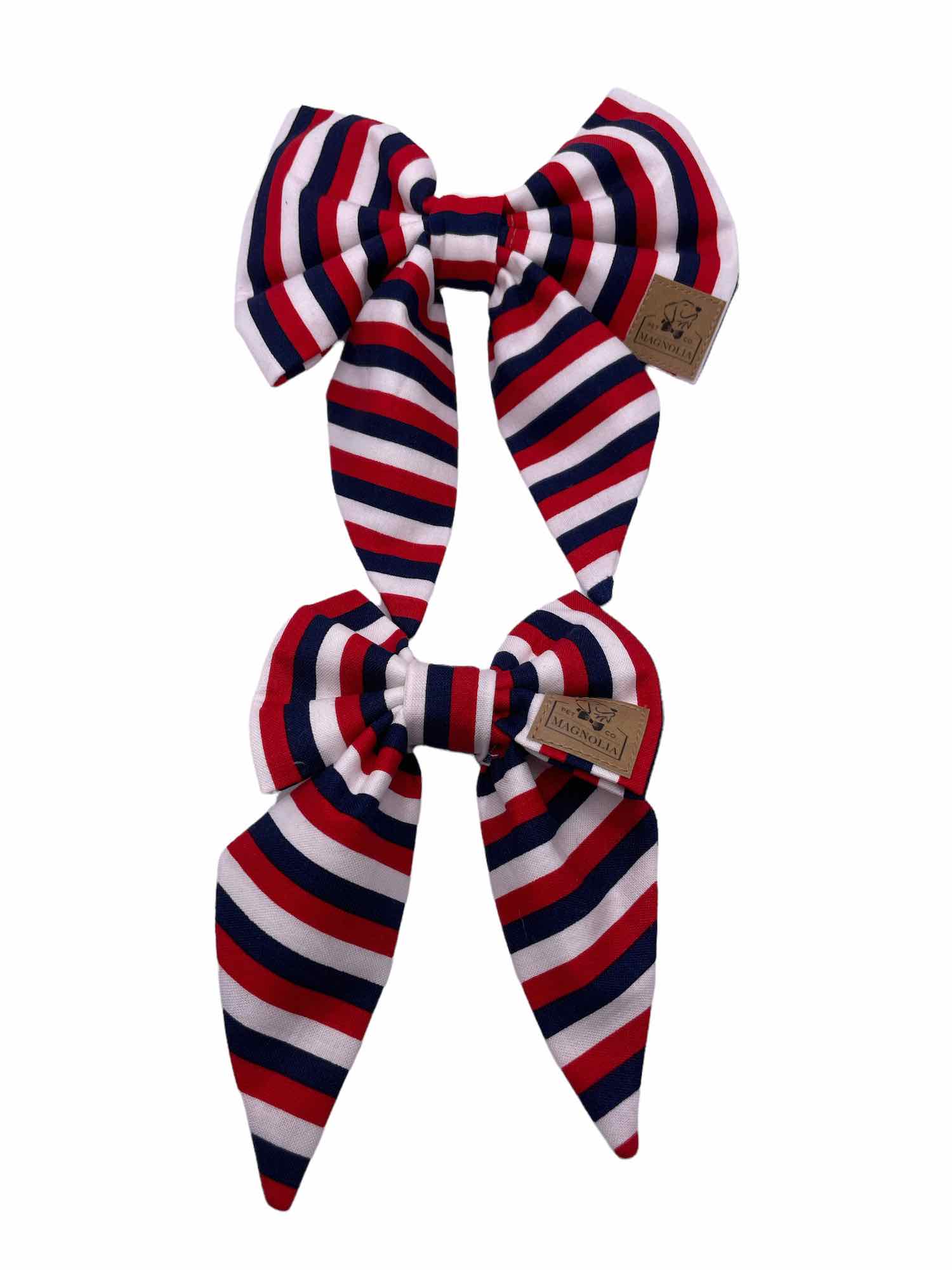 Add a touch of classic Americana to your dog's look with our Red, White, and Blue Striped Dog Bow.  Handmade in the USA.