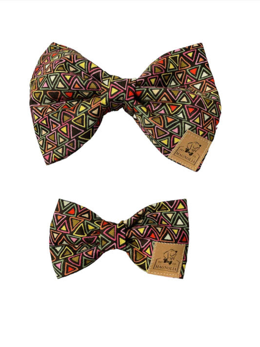 Add a pop of color and a touch of modern flair to your dog's look with our Triangle Maze Dog Bow Tie on a black fabric background. This eye-catching accessory combines vibrant hues with sleek design, making it the perfect choice for style-conscious pet owners