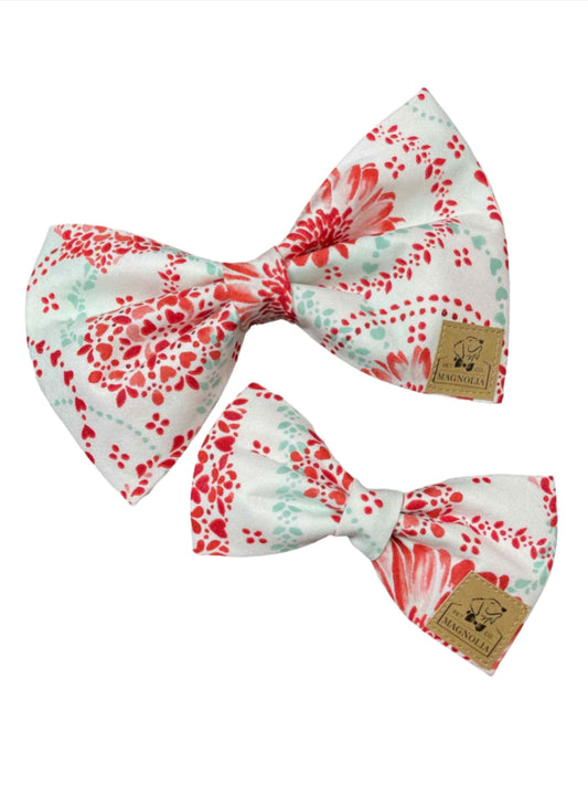 Dress your furry friend in style this Valentine's Day in this charming Valentine dog bow tie. Adorned with delicate red hearts and vibrant red flowers, this bow tie is the perfect accessory to show off your pup's lovable personality. 