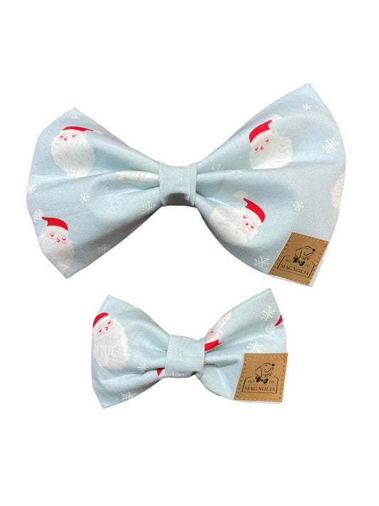 Celebrate the holiday season in style with our adorable dog bow featuring a jolly Santa &nbsp;face on a light blue fabric background. This festive accessory is perfect for adding a touch of holiday cheer to your furry friend's wardrobe